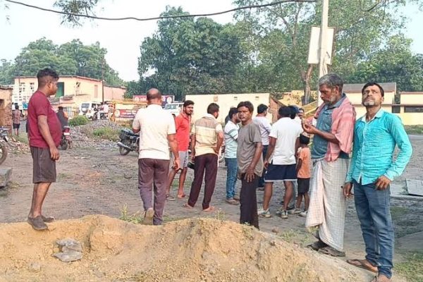 बाघमारा के सोनारडीह थाना के सामने पंप ऑपरेटर को गोली मारे जाने के बाद जांच करती पुलिस।
